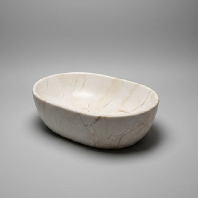 Marble basin on a light gray surface with a blurred background